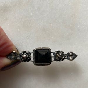 Black and silver pin
